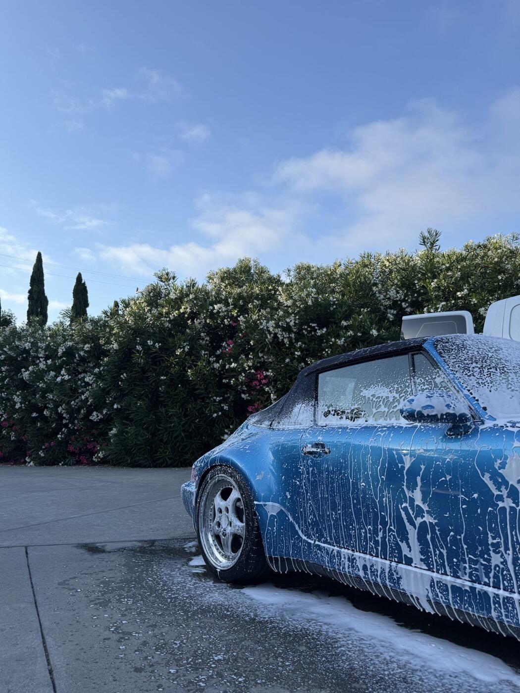 A blue Porsche under foam