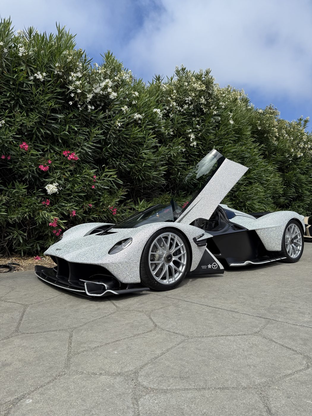 A crystal-wrapped Aston Martin Valkyrie, doors up, after a detail